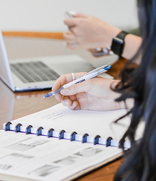 Image of a female accountant writing in a book